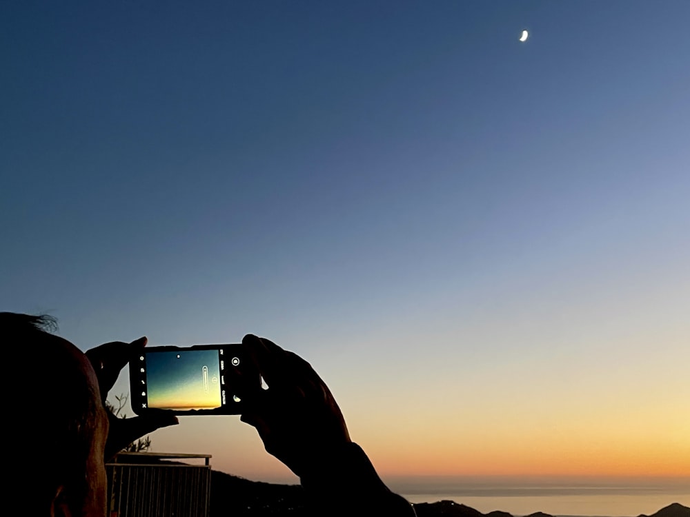 a person taking a picture with a cell phone