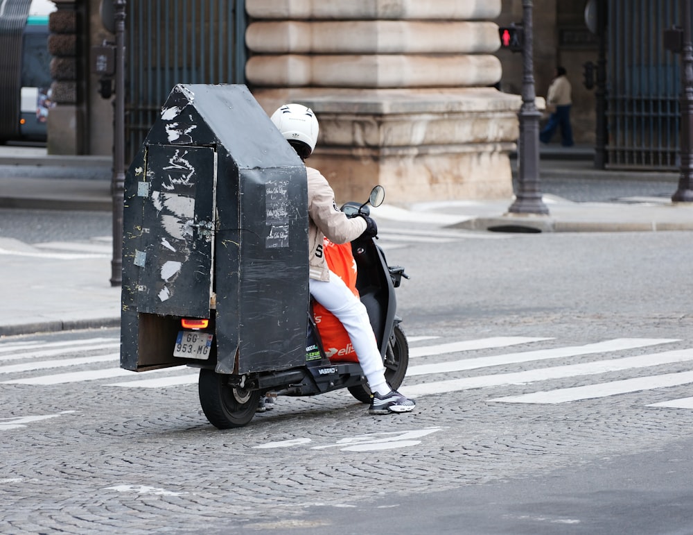 a person riding a scooter on a city street