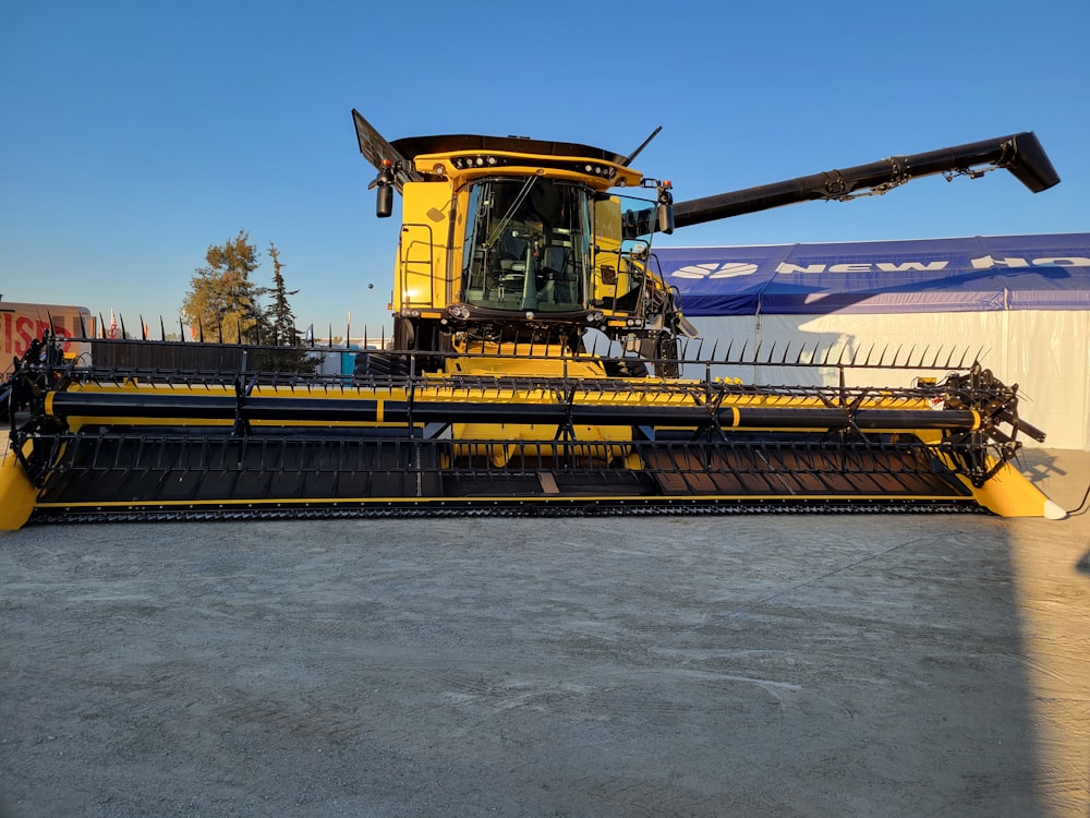 a large yellow machine is parked in a lot