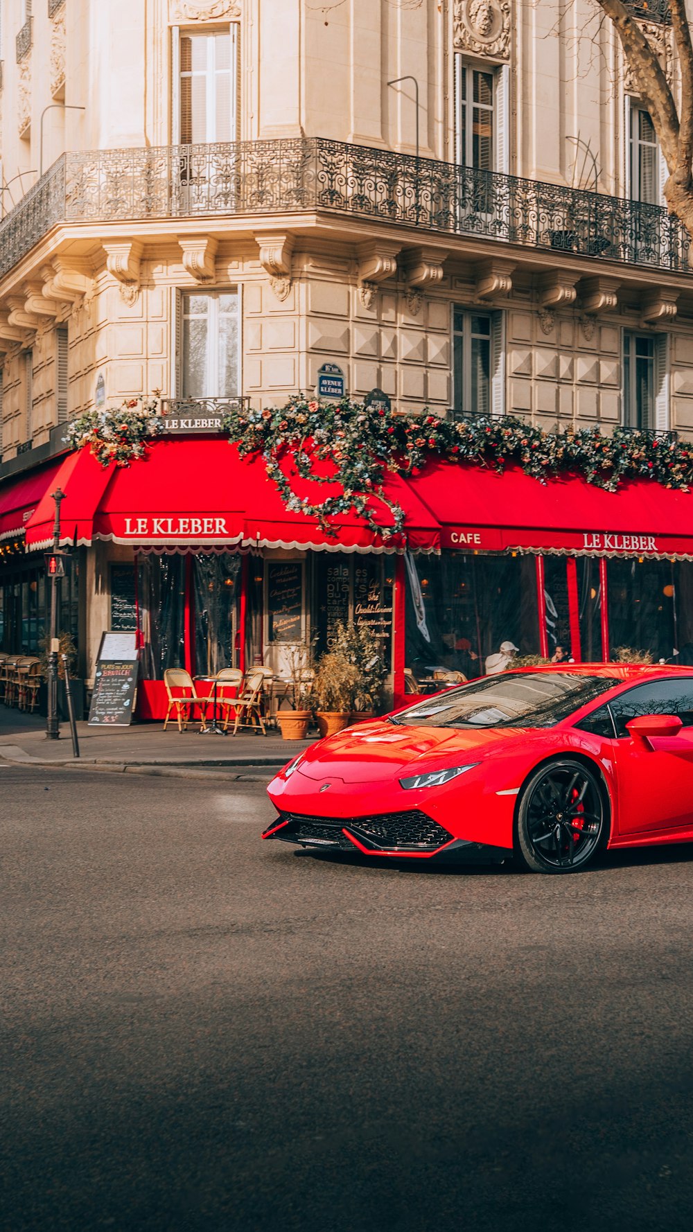 a red sports car parked in front of a building