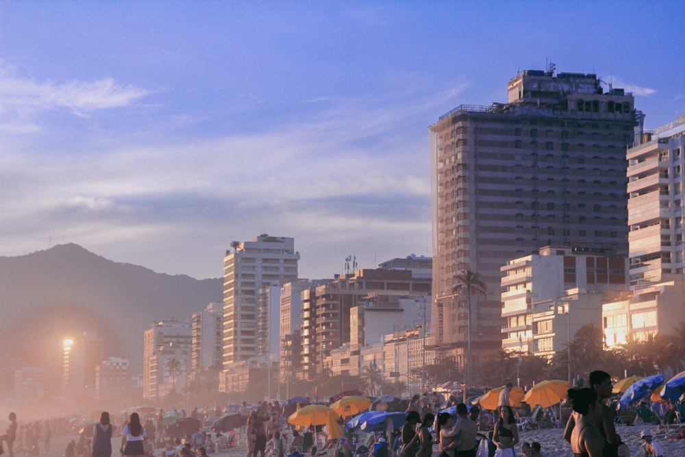 a crowd of people standing on top of a sandy beach