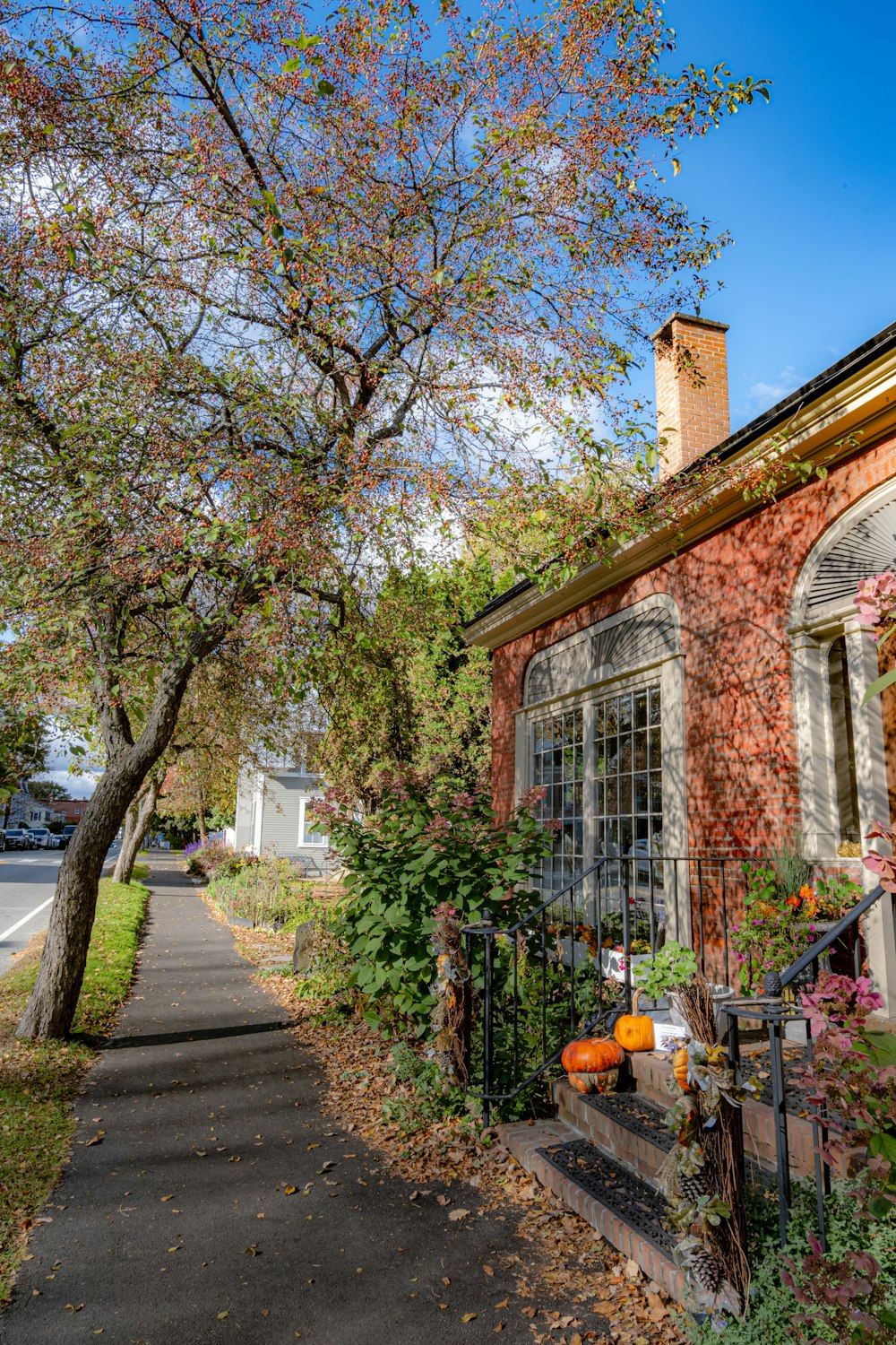 a brick house with a black iron fence