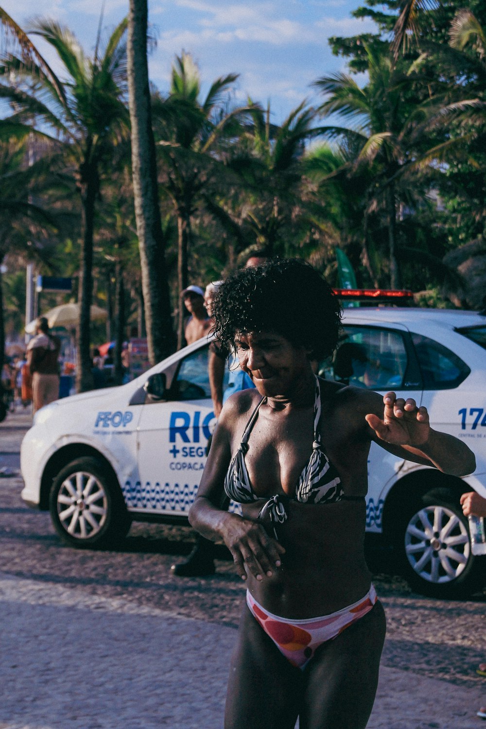 a woman in a bikini riding a skateboard