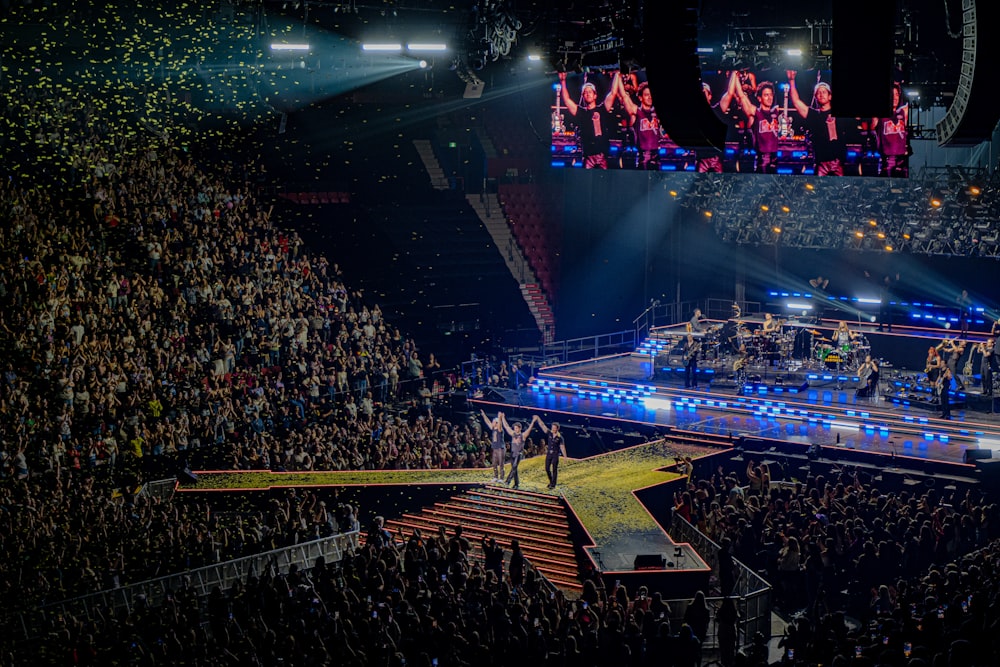 a large group of people standing on top of a stage