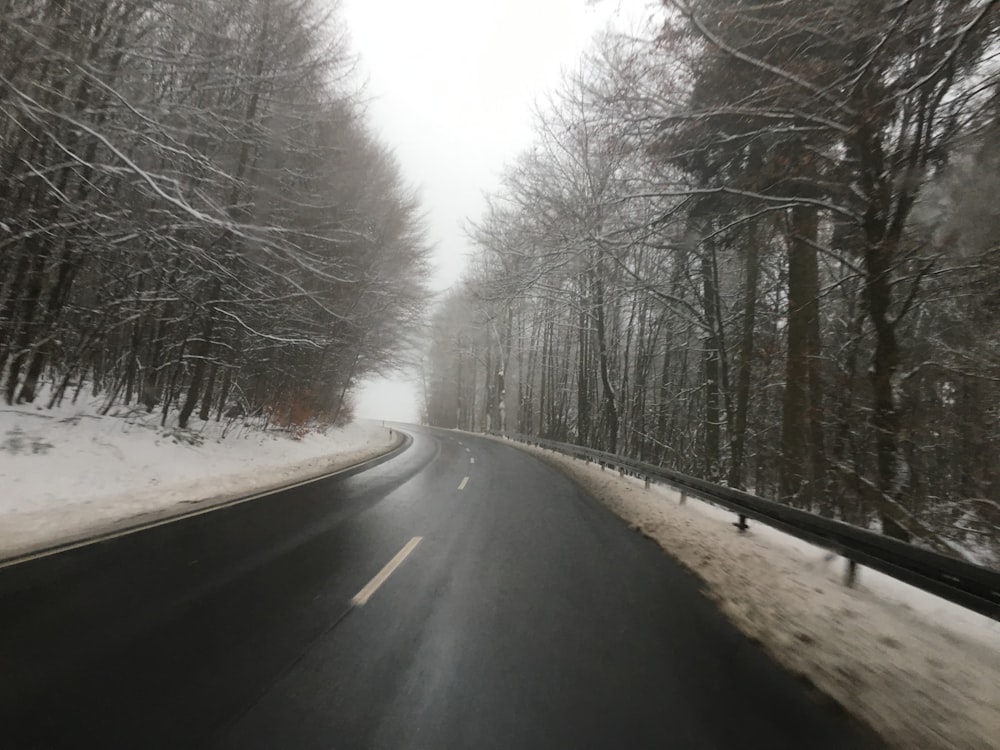 a car driving down a snow covered road