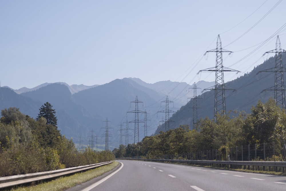 an empty road with mountains in the background