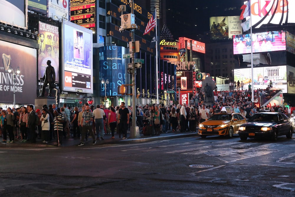 a crowd of people standing on the side of a street