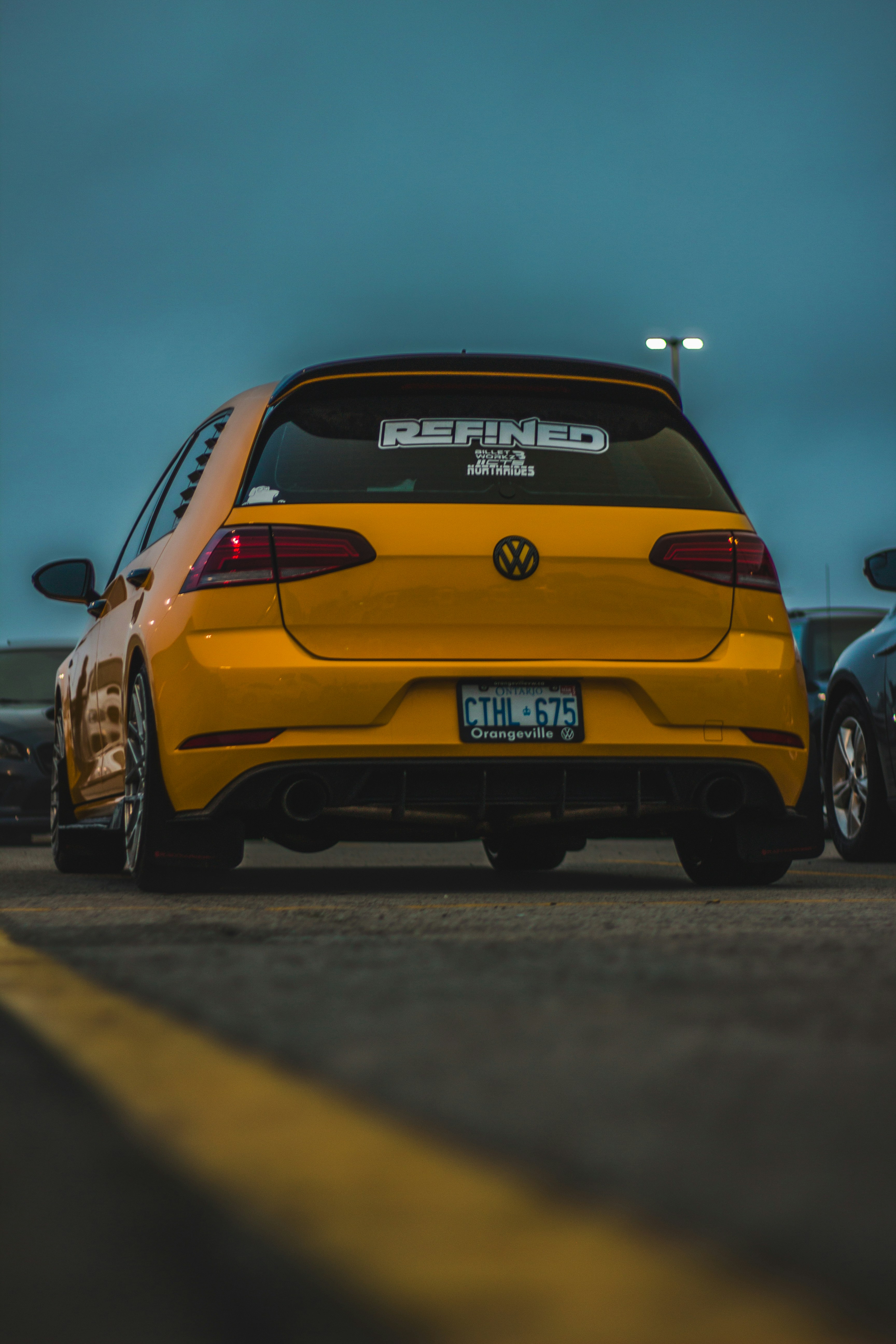 a yellow car parked on the side of the road