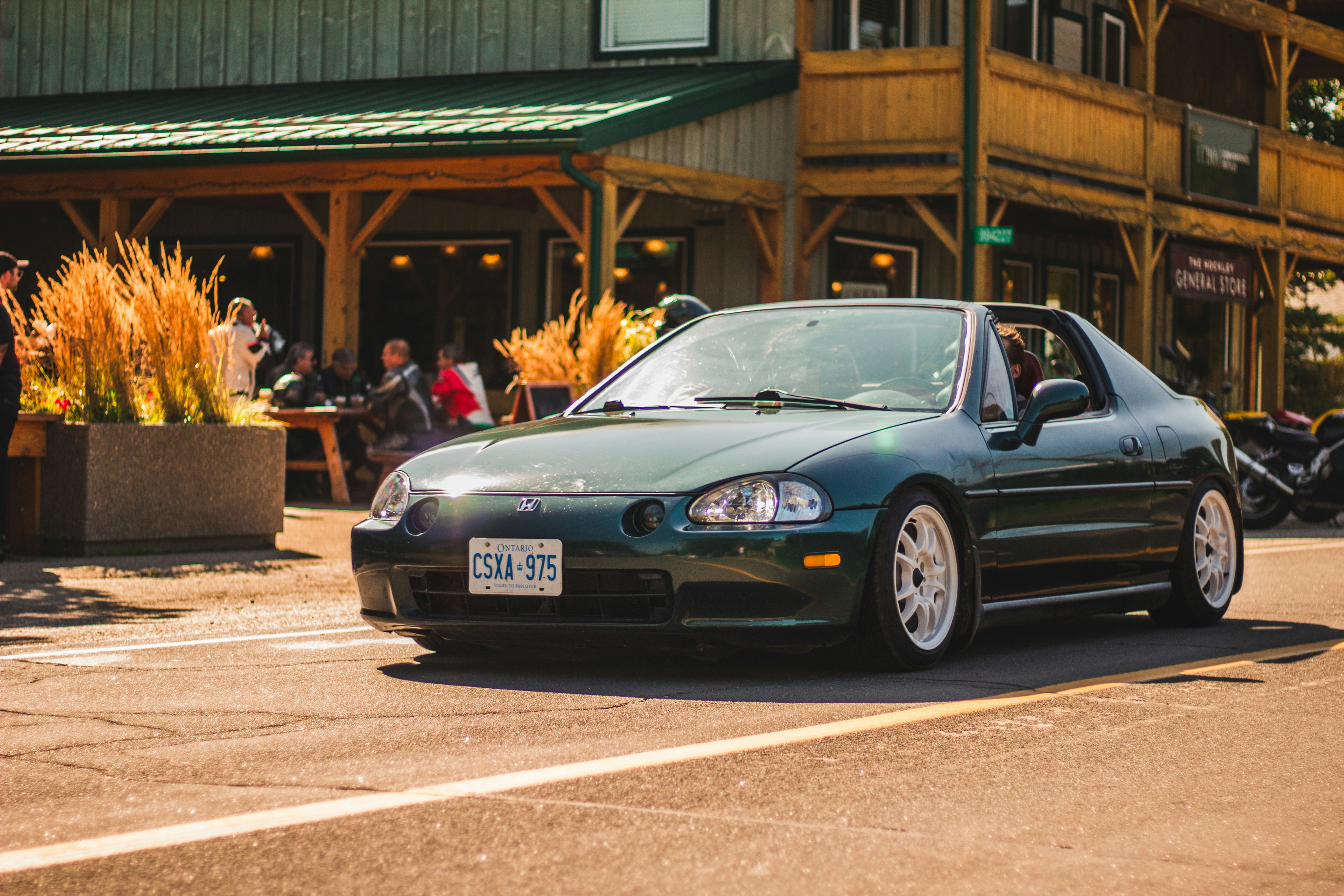 a green car parked on the side of the road