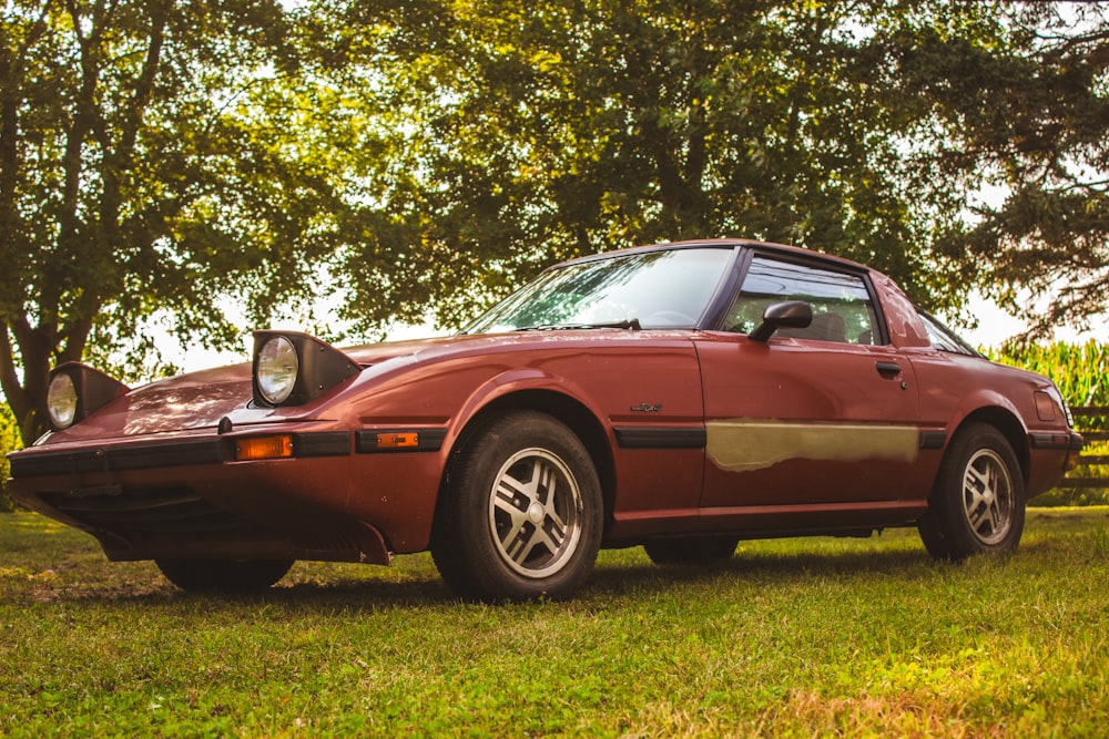 a red sports car parked in the grass