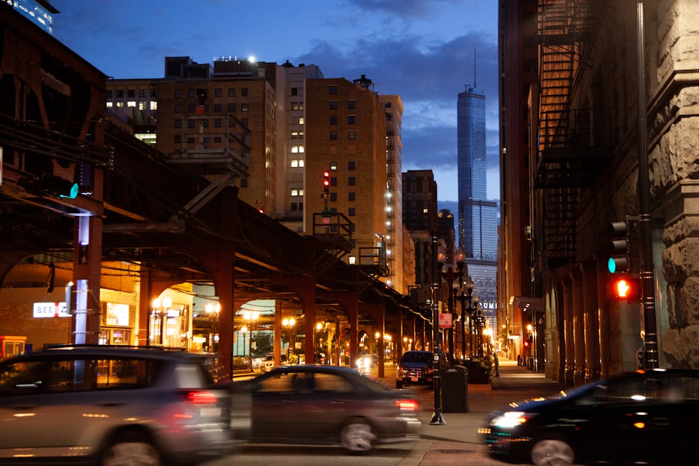 a busy city street at night with cars passing by