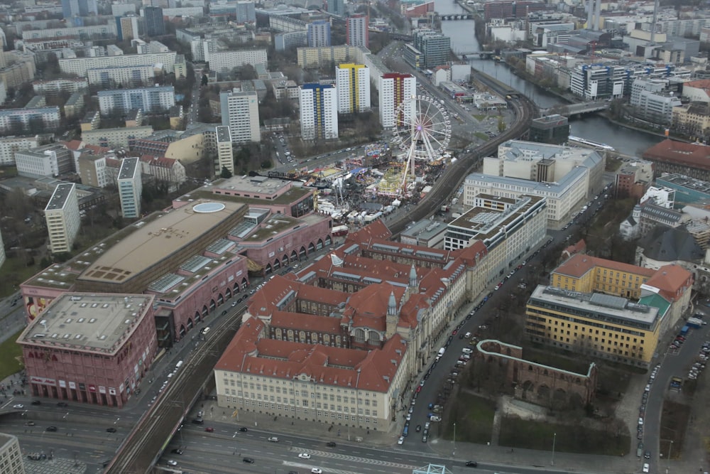 an aerial view of a city with a ferris wheel