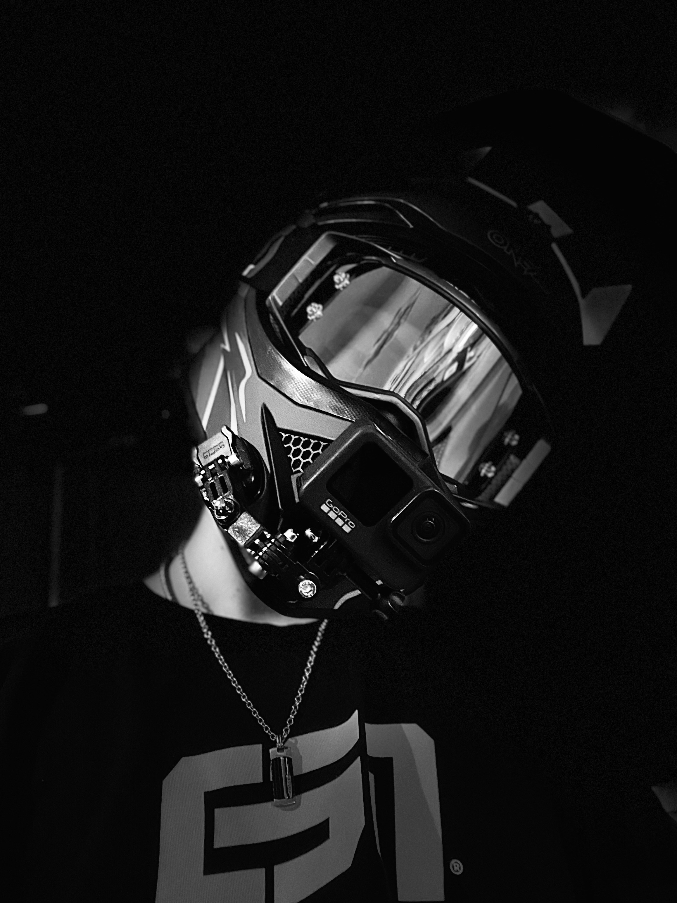 a man wearing a helmet and chain around his neck