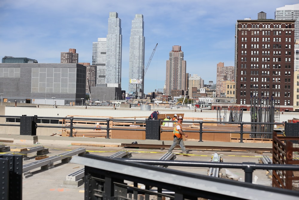 a construction worker standing on top of a roof