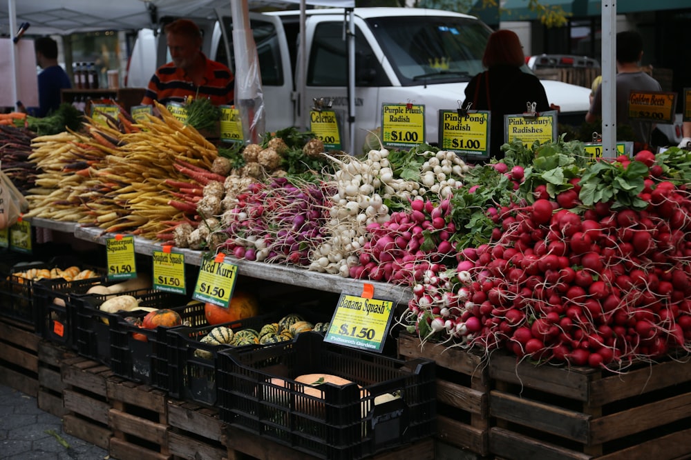 a bunch of vegetables are on display at a market