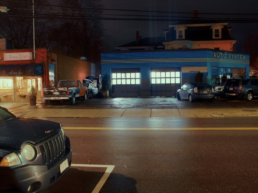 a couple of cars parked in front of a building