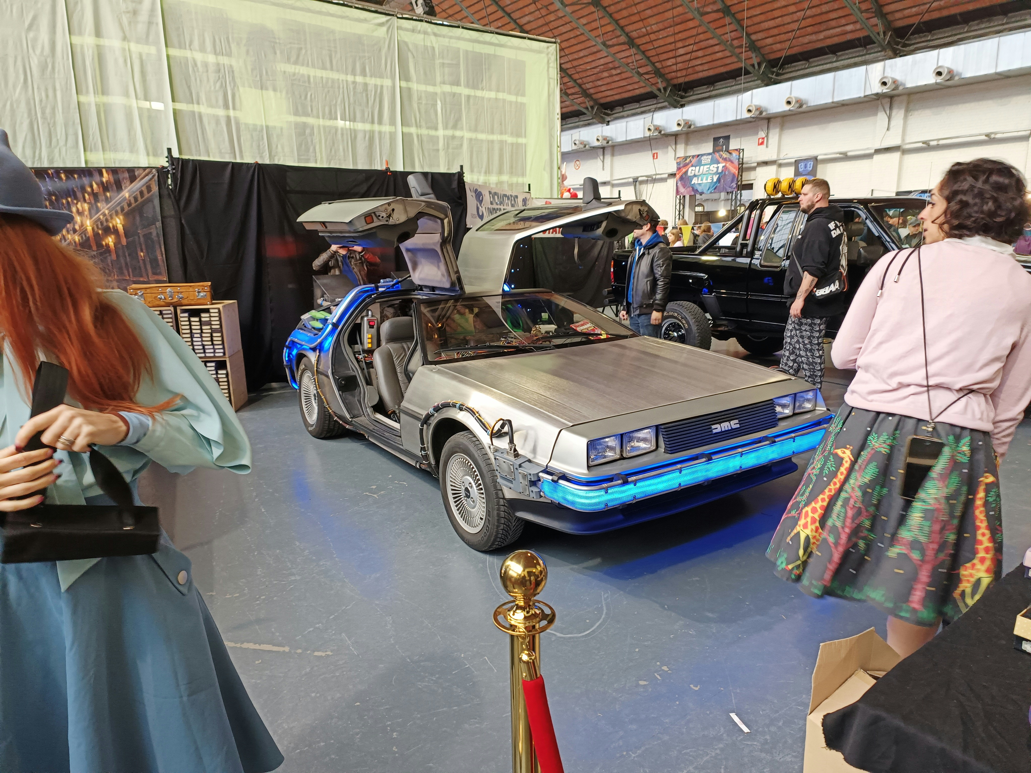 a group of people standing around a car