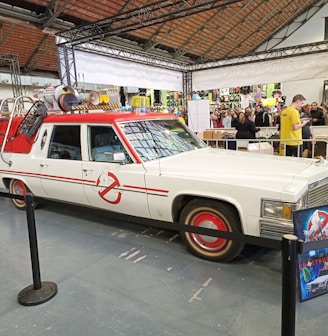 a white station wagon with a red stripe on it