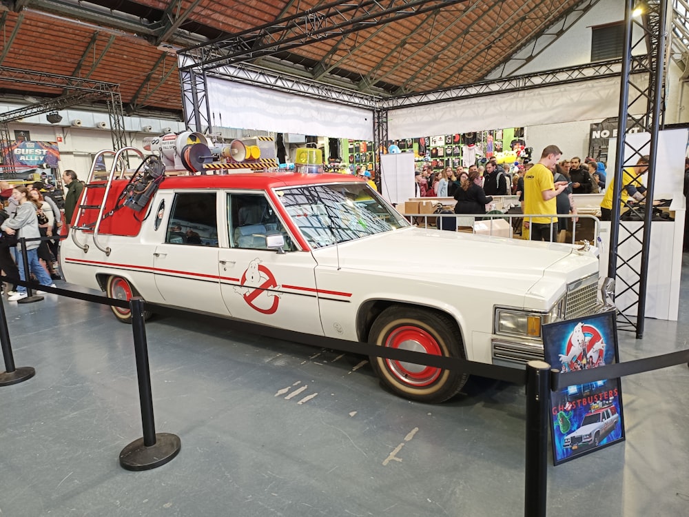 a white station wagon with a red stripe on it