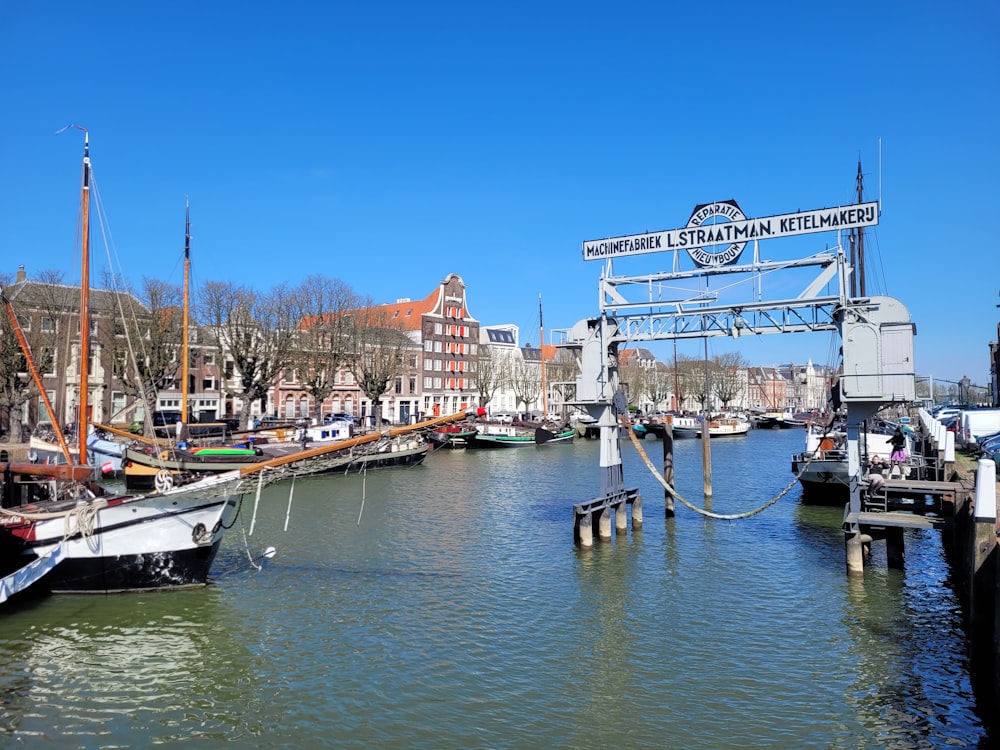 a harbor filled with lots of boats next to tall buildings