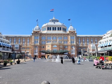 a large building with a fountain in front of it