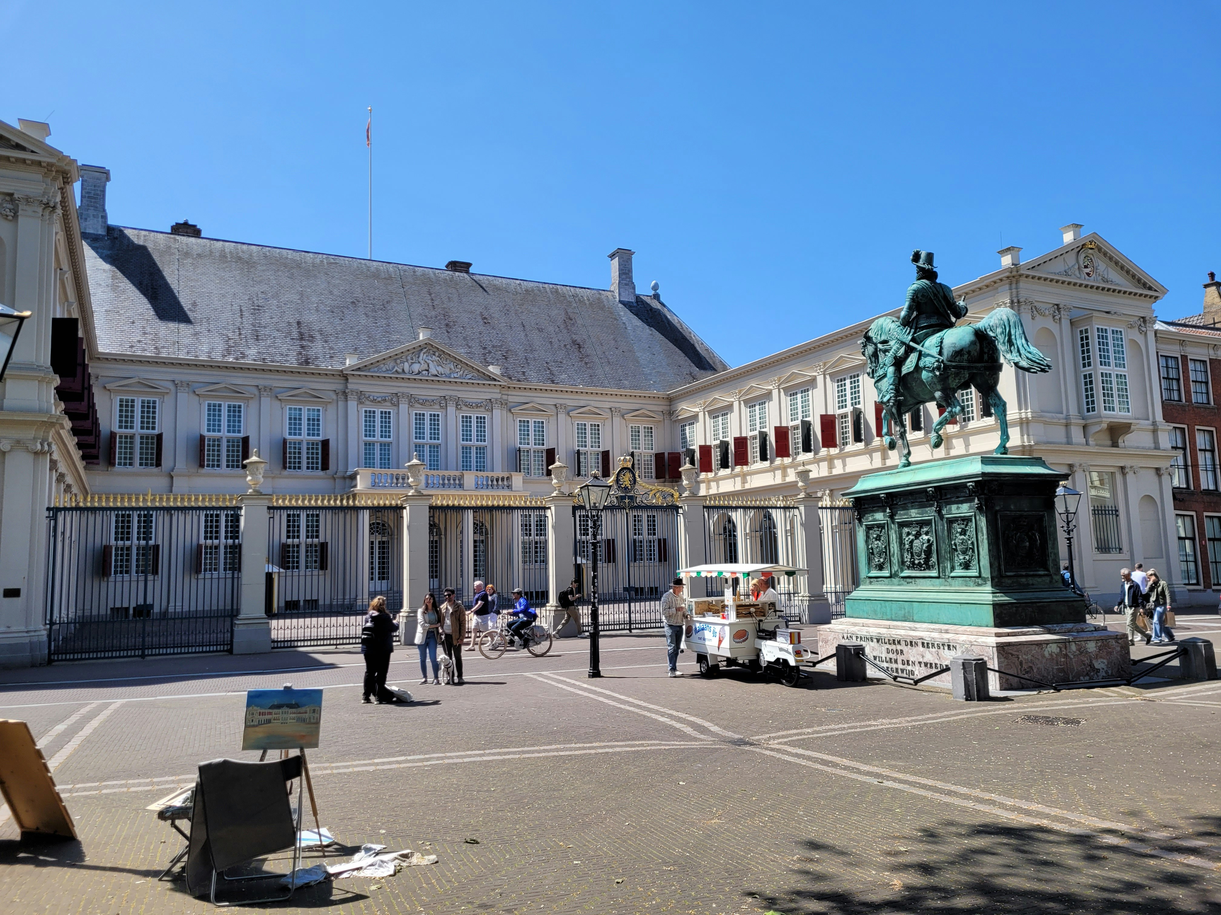 a statue of a man on a horse in front of a building