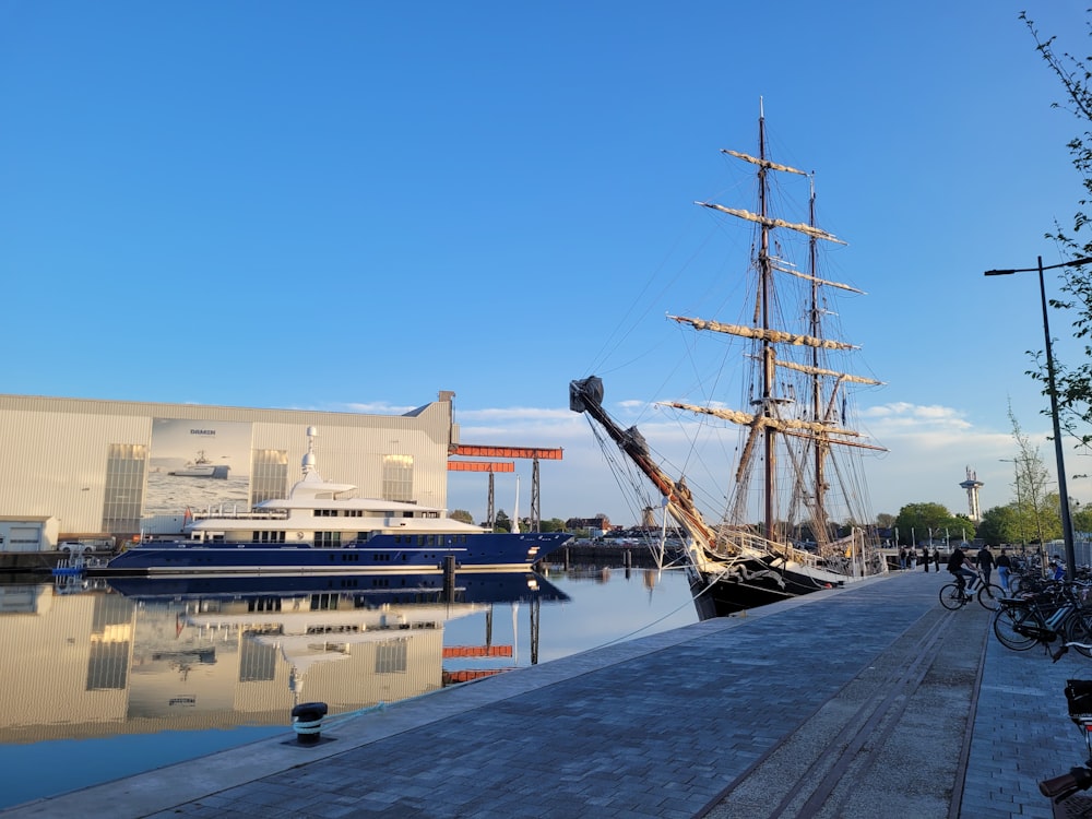 a large boat docked in a harbor next to a building