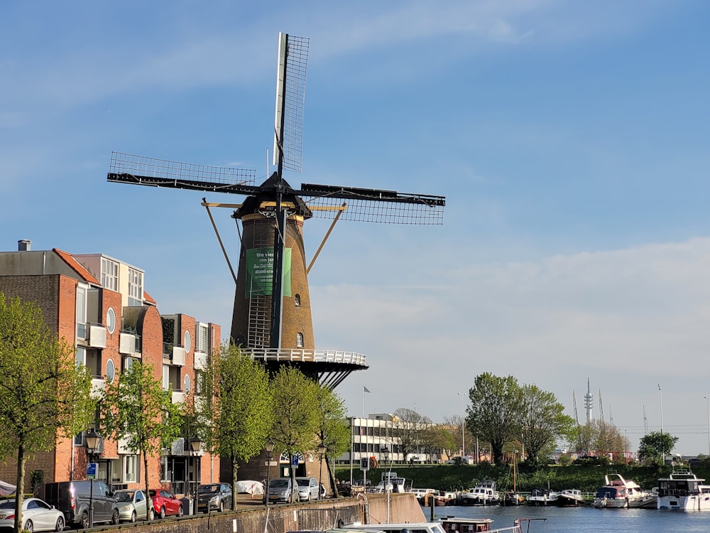 a windmill on the side of a river