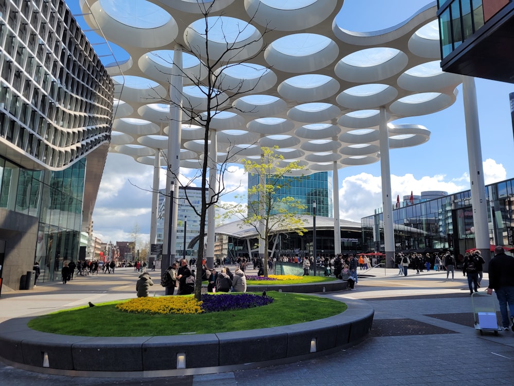 a group of people walking around a city square