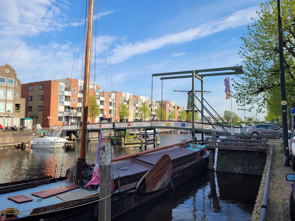 a boat is docked in the water next to a bridge