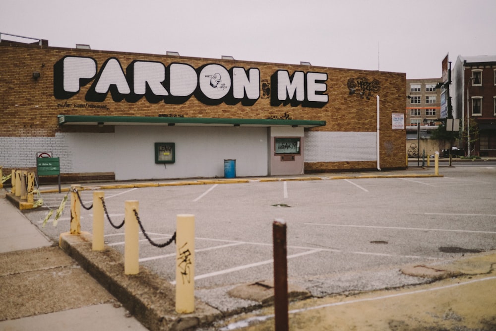 an empty parking lot with a store front