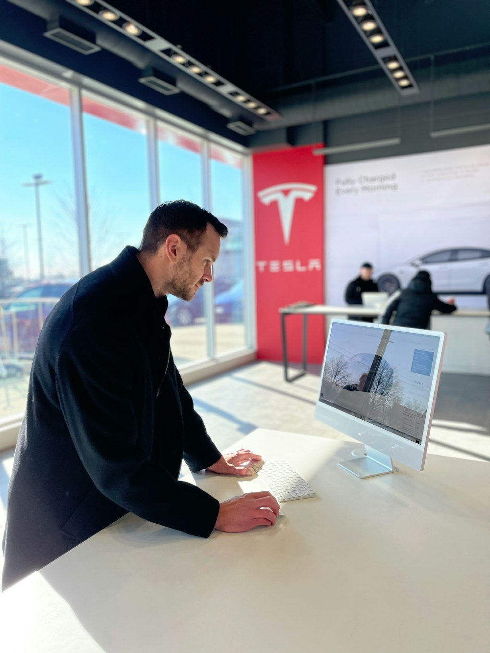 a man sitting at a desk in front of a computer