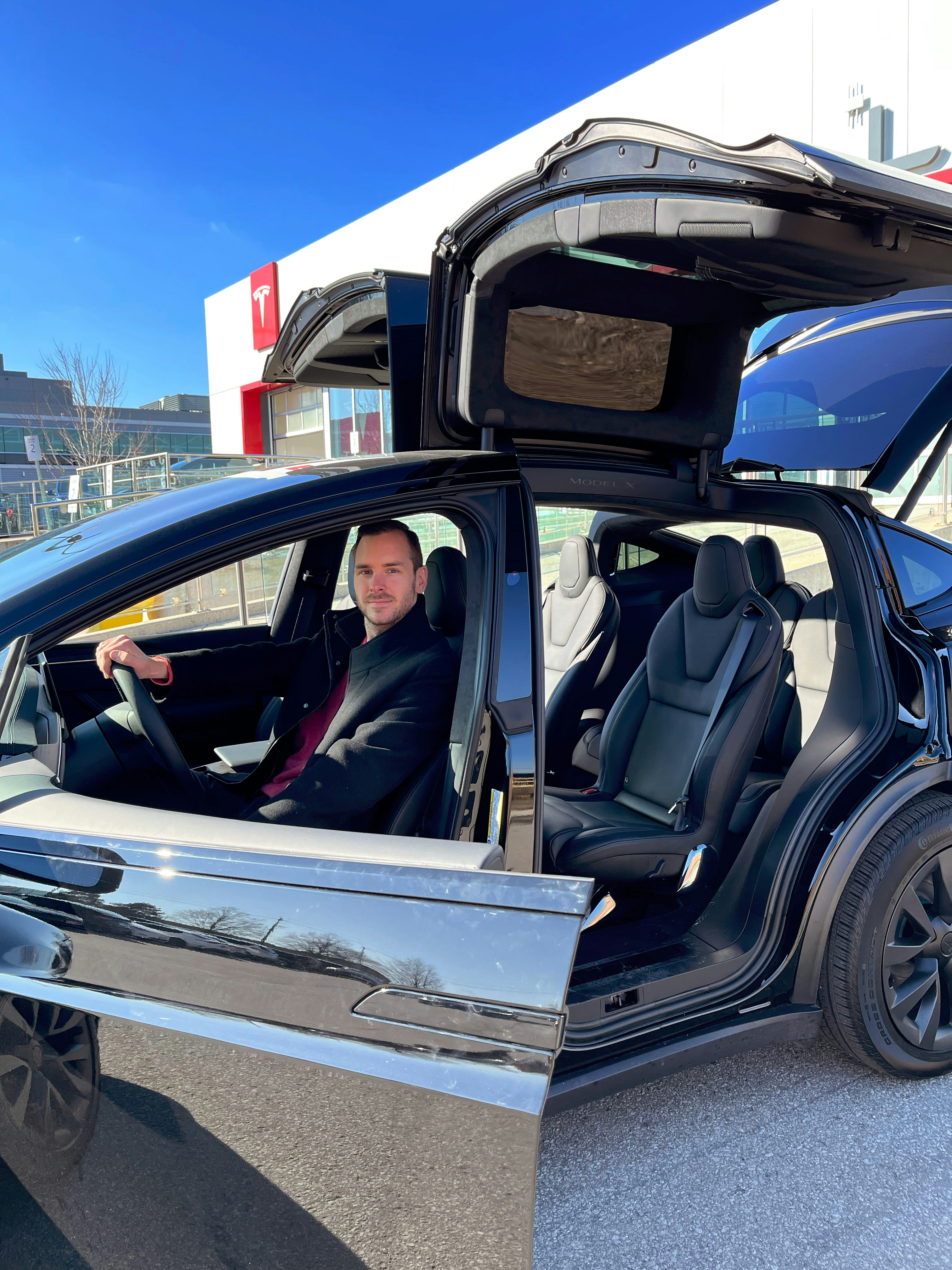 a man sitting in the driver's seat of a car