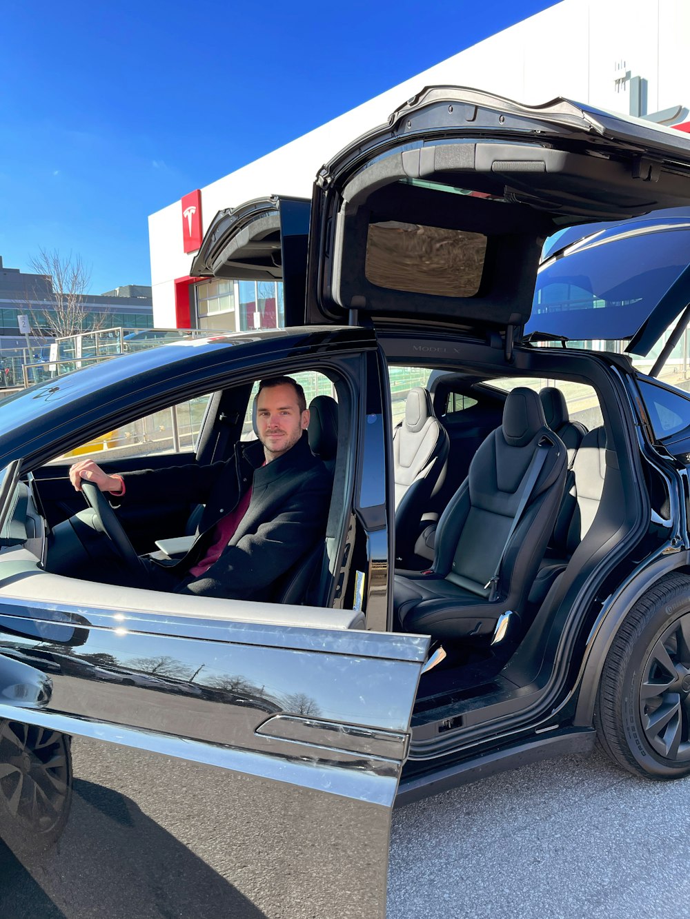 a man sitting in the driver's seat of a car