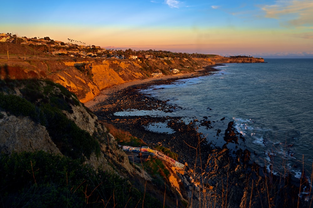 a scenic view of a beach and a cliff