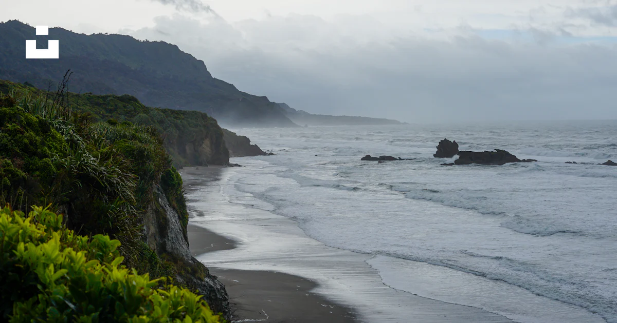 Une vue d’une plage avec des vagues qui arrivent sur le rivage photo ...