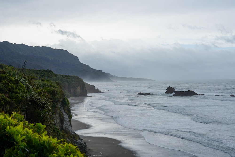 a view of a beach with waves coming in to shore