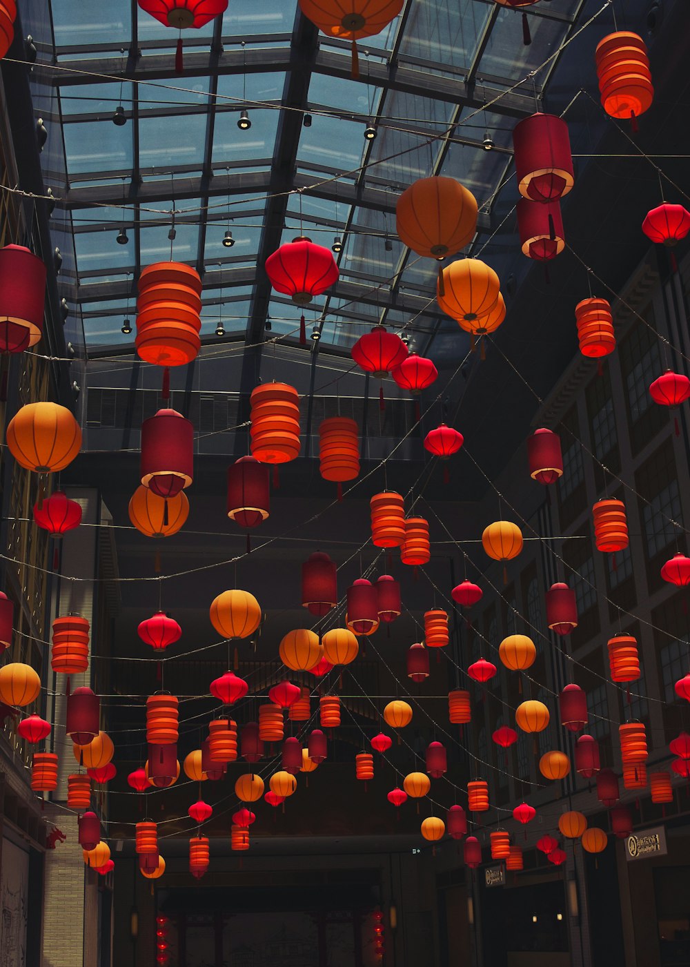 a room filled with lots of red and orange lanterns