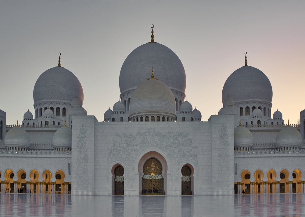 a large white building with three domes on top of it