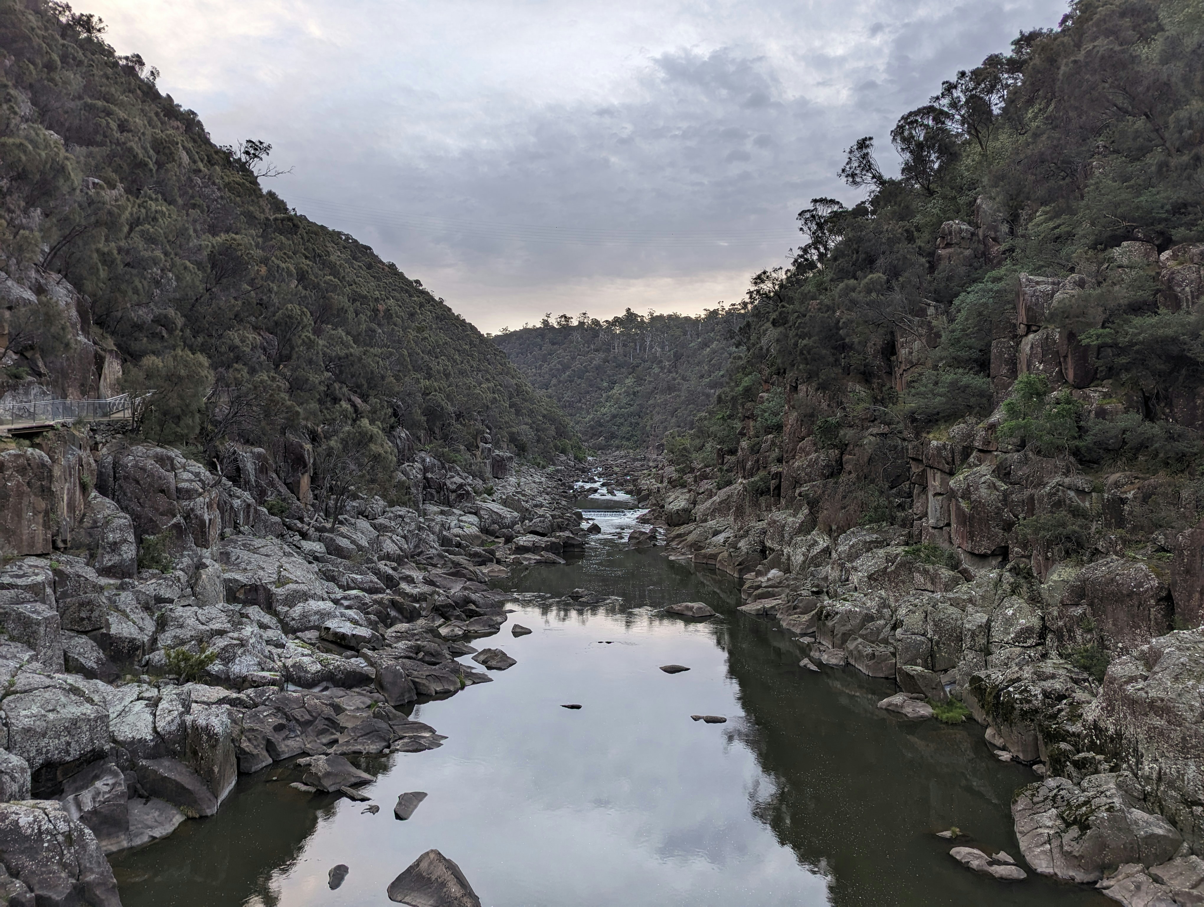 a body of water surrounded by rocks and trees