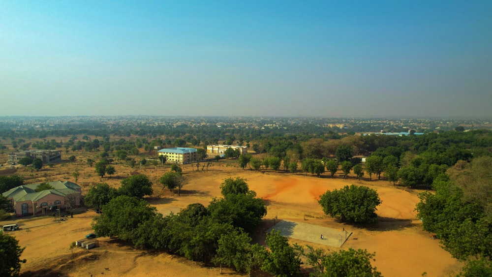 an aerial view of a rural area with trees and buildings