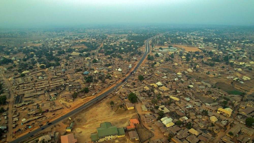 an aerial view of a village and a road