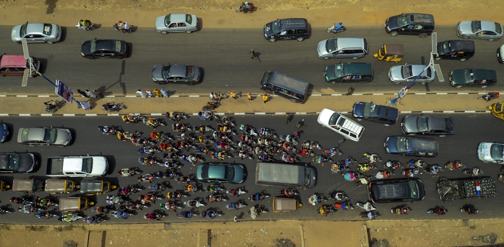 a group of people standing on the side of a road