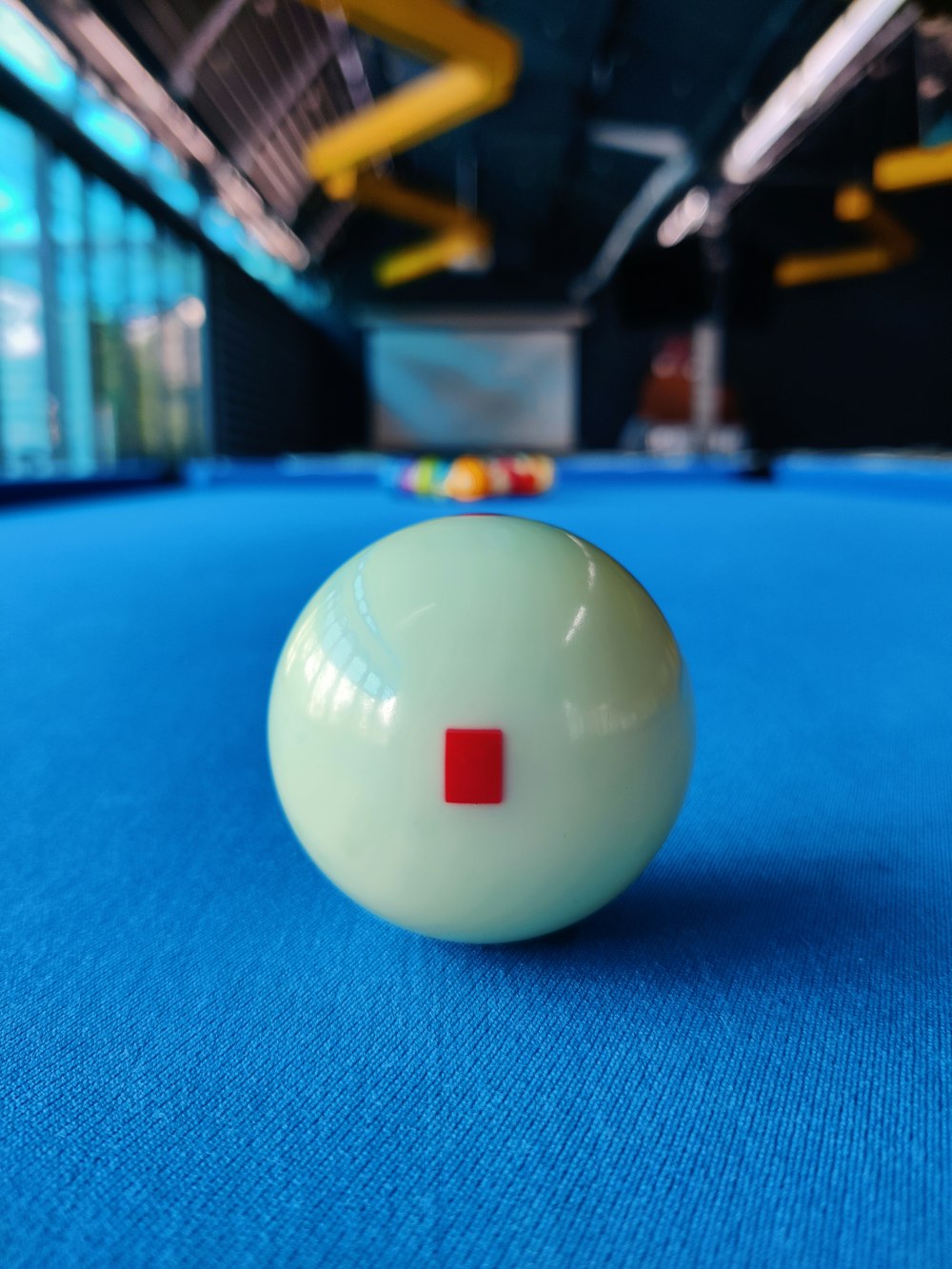 a pool ball sitting on top of a blue pool table