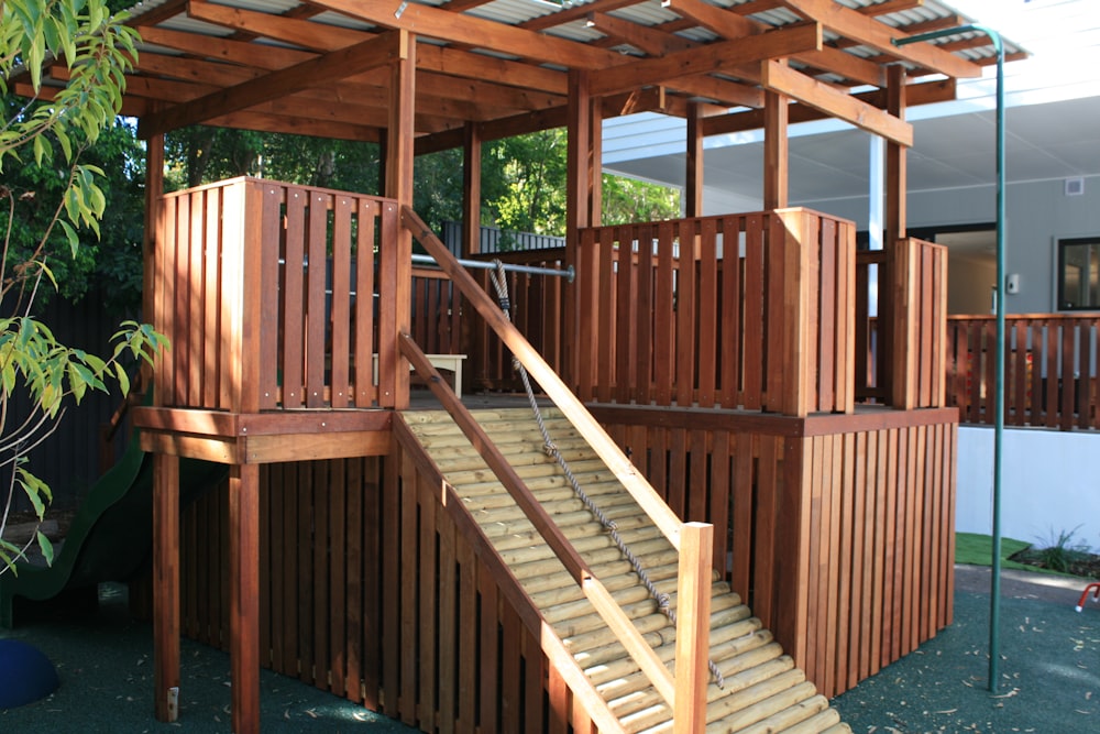 a wooden play structure with a slide