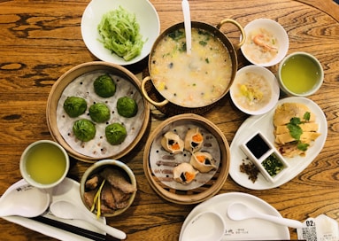 a wooden table topped with bowls of food