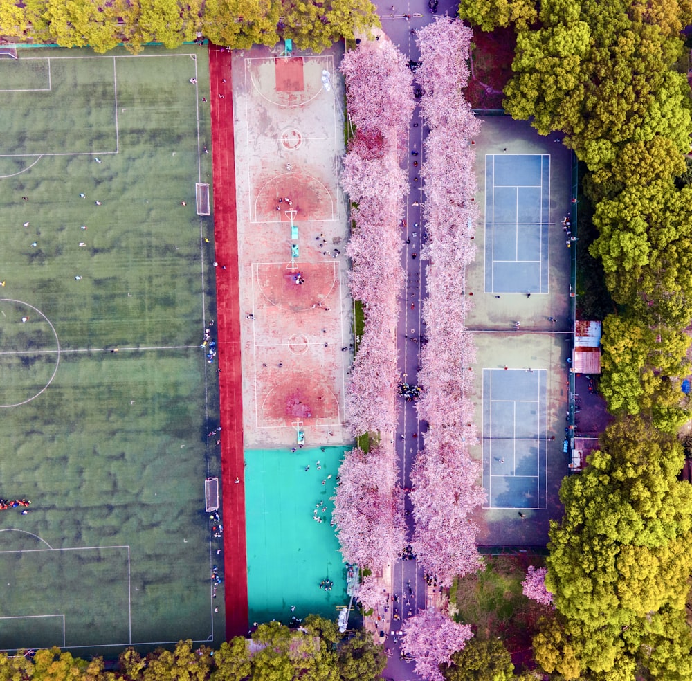 an aerial view of a soccer field surrounded by trees