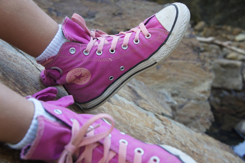 a close up of a person wearing pink shoes