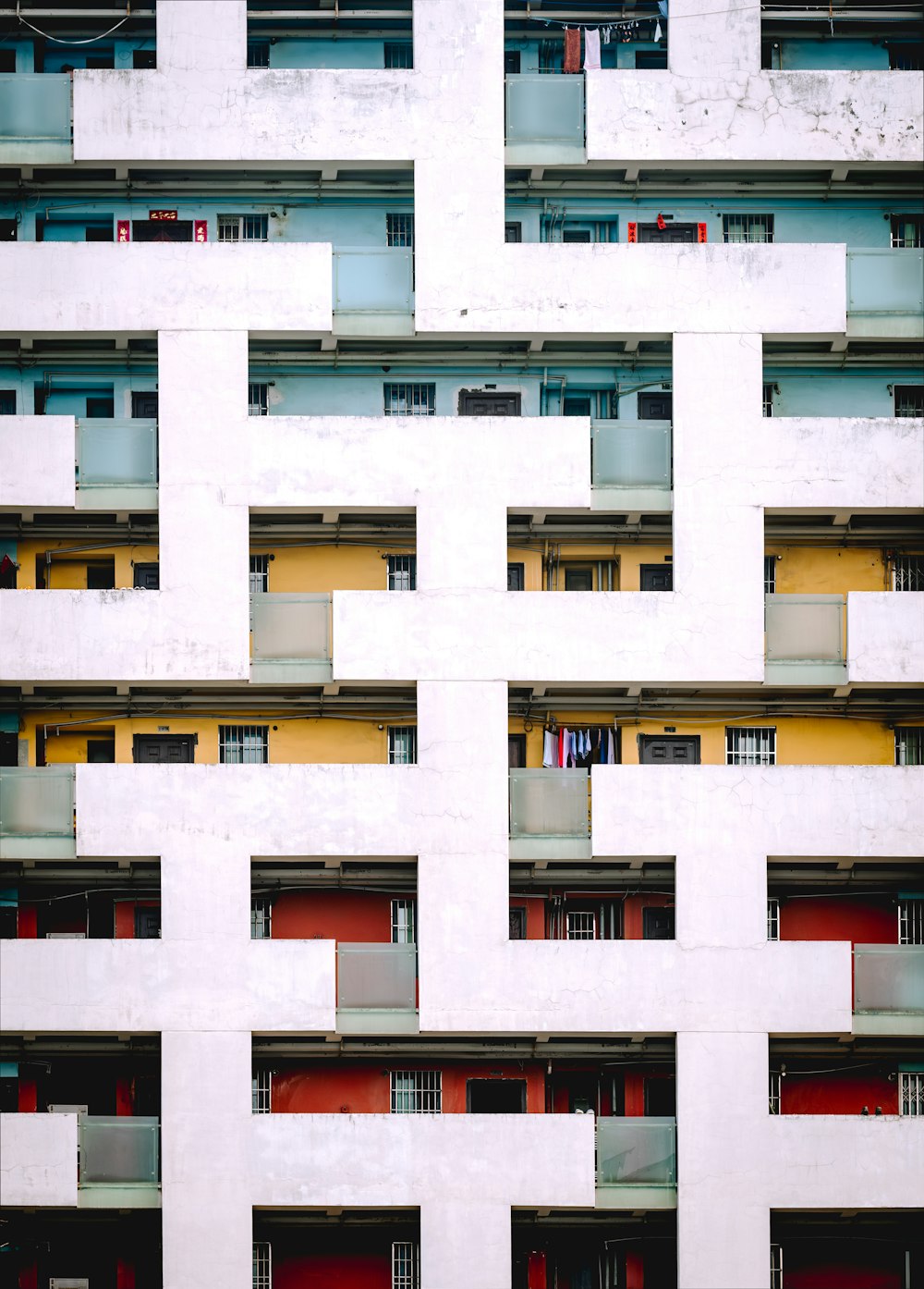 a white building with red doors and windows