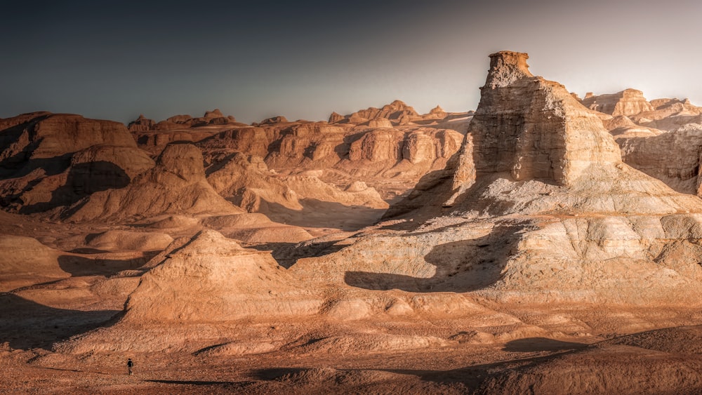 a desert landscape with a mountain range in the background